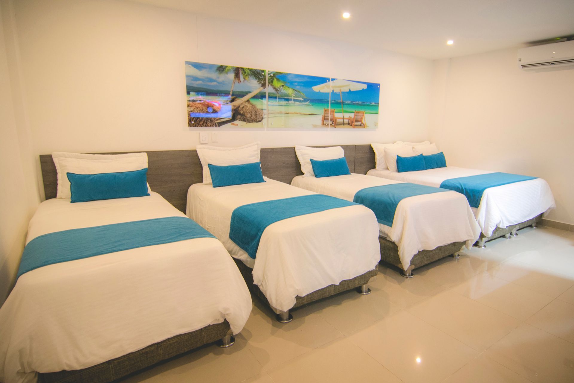 Large family hotel room with four single beds for your group vacation at a top beach hotel in Coveñas Colombia