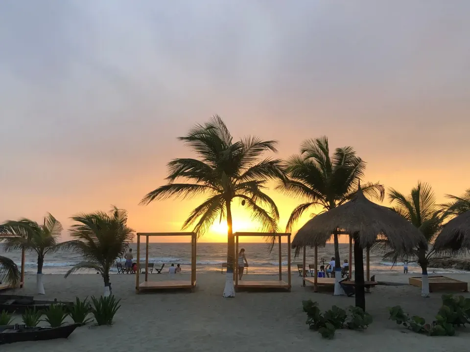 Sunset on Coveñas beach in front of Hotel Poblado surrounded by palm trees