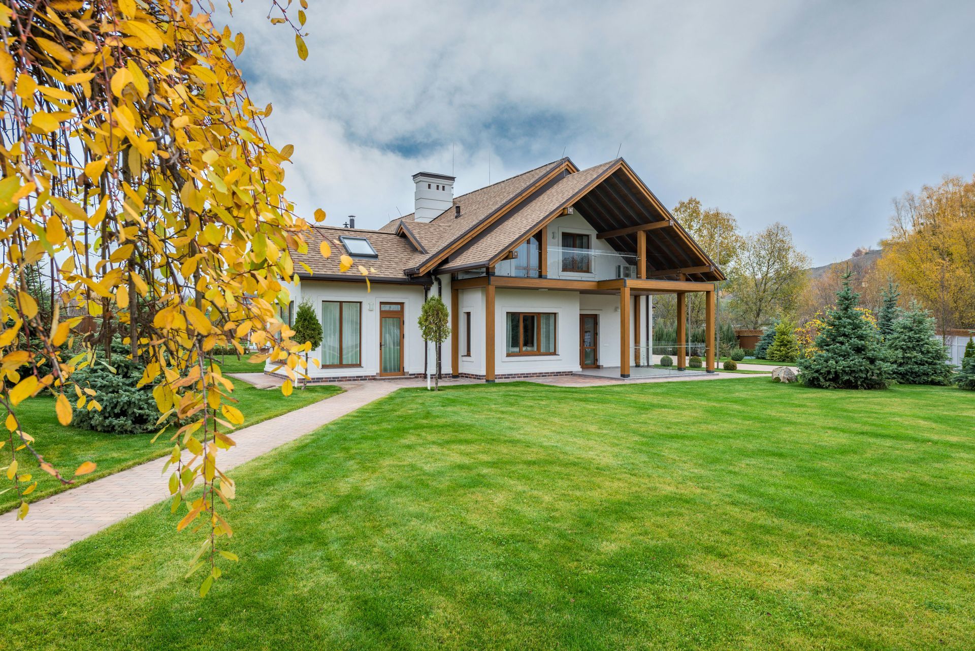A large house with a lush green lawn in front of it. - abraham sanieoff
