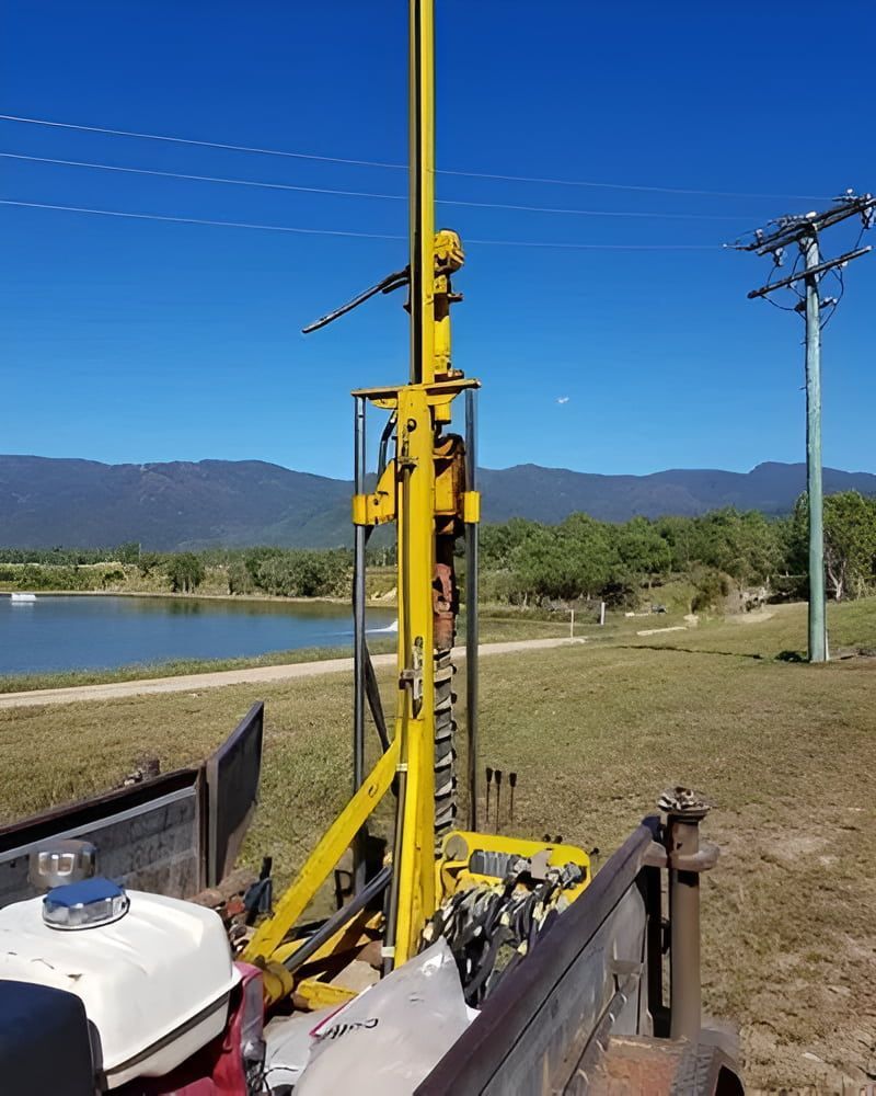 A Yellow Drill Is Sitting In The Back Of A Truck — PGI North QLD In Ingham, QLD