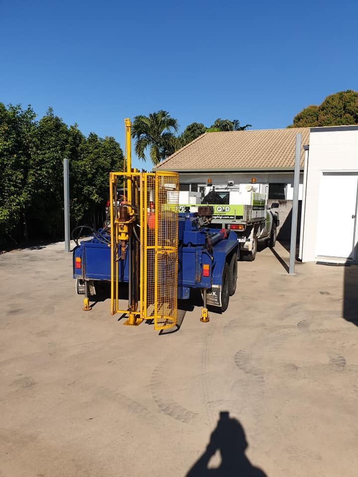 A Blue Trailer With A Yellow Drill On It Is Parked — PGI North QLD In Ingham, QLD