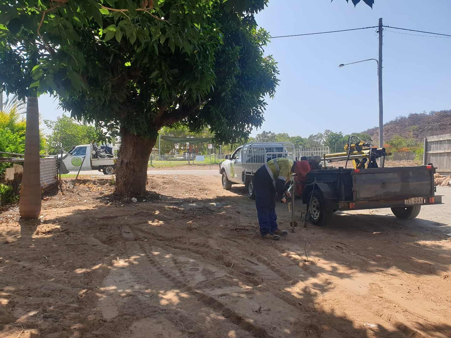 A Man Is Standing Next To A Truck With A Trailer — PGI North QLD In Rosslea, QLD