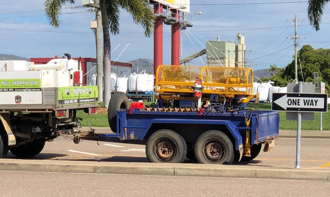 A Truck With A Trailer Attached To It Is Parked On The Side — PGI North QLD In Rosslea, QLD