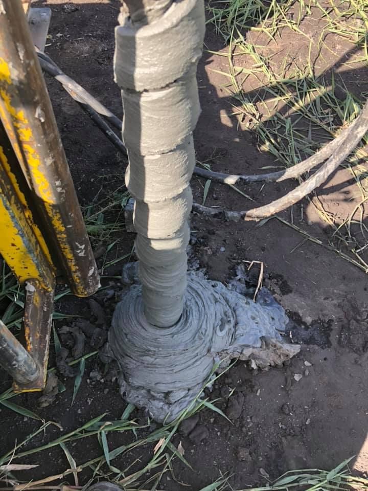 A Drill Bit Is Being Used To Drill A Hole In The Ground — PGI North QLD In Rosslea, QLD