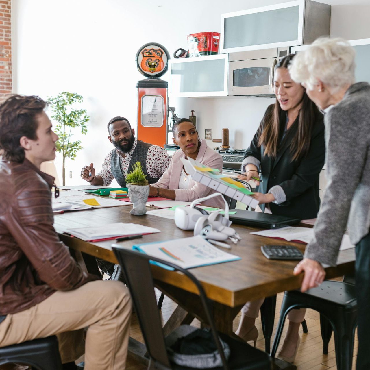A group of people are sitting around a table talking