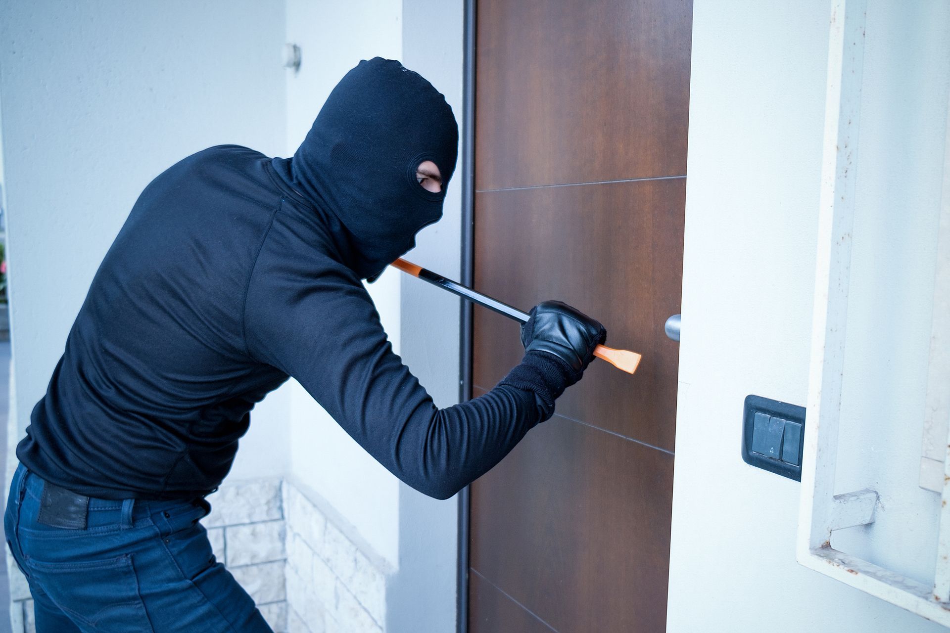 Burglar trying to force a door lock.