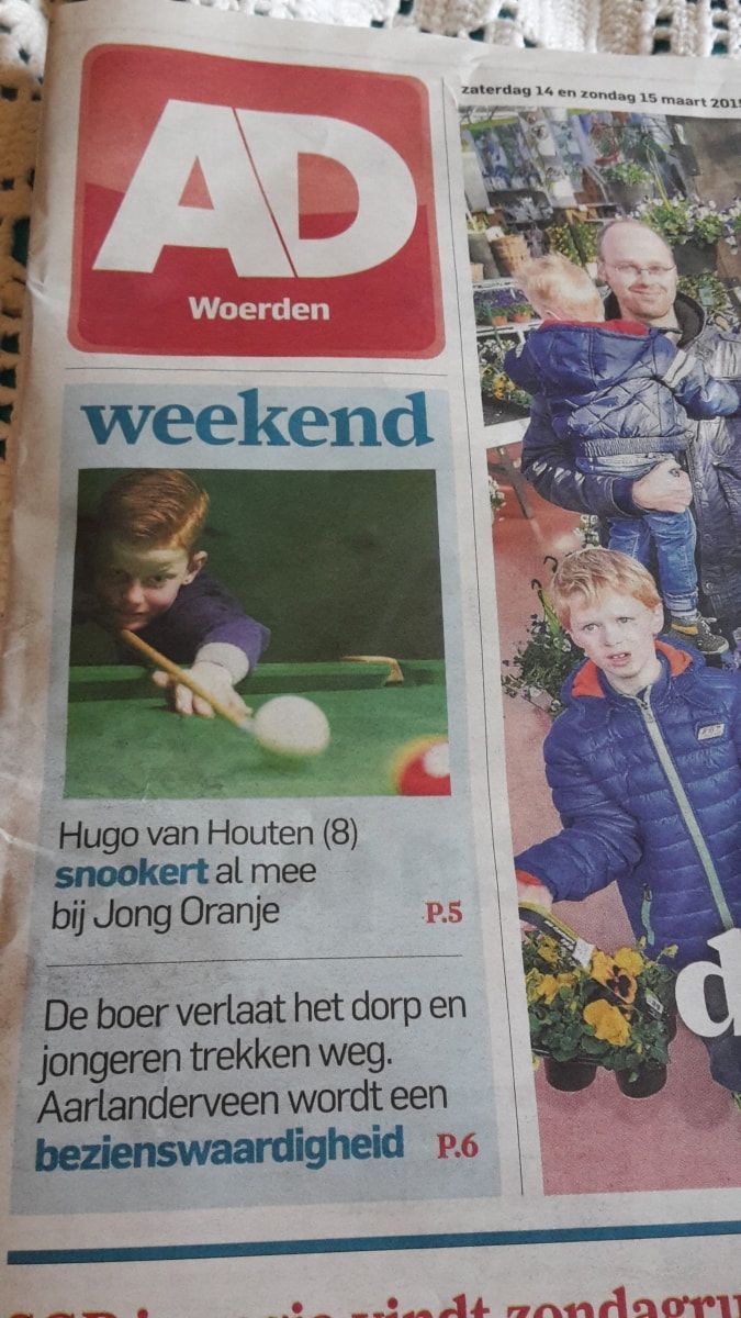 AD Woerden newspaper with a boy playing snooker, article about a town.