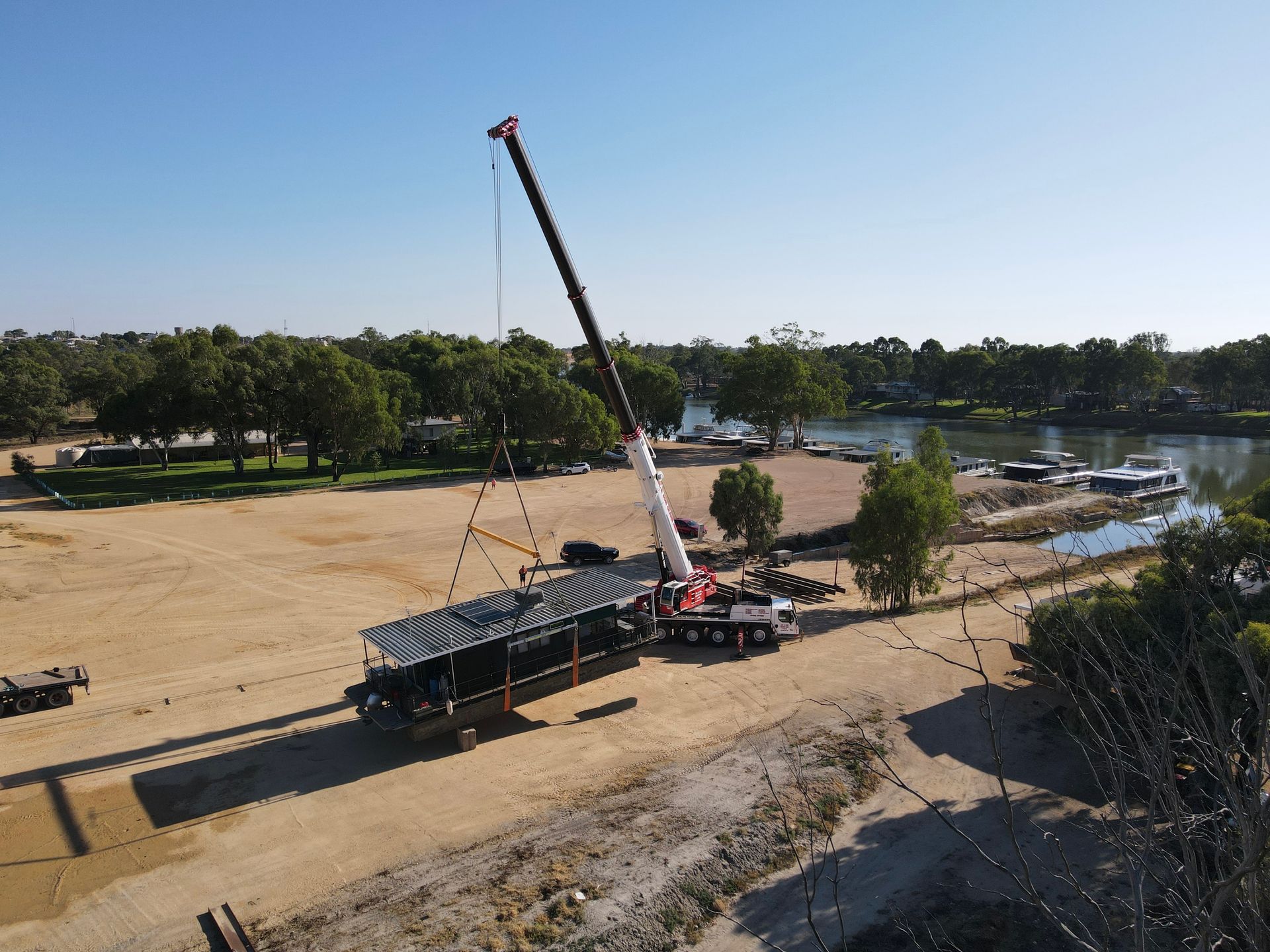  Our powerful 160T crane and highly skilled riggers lifting a houseboat