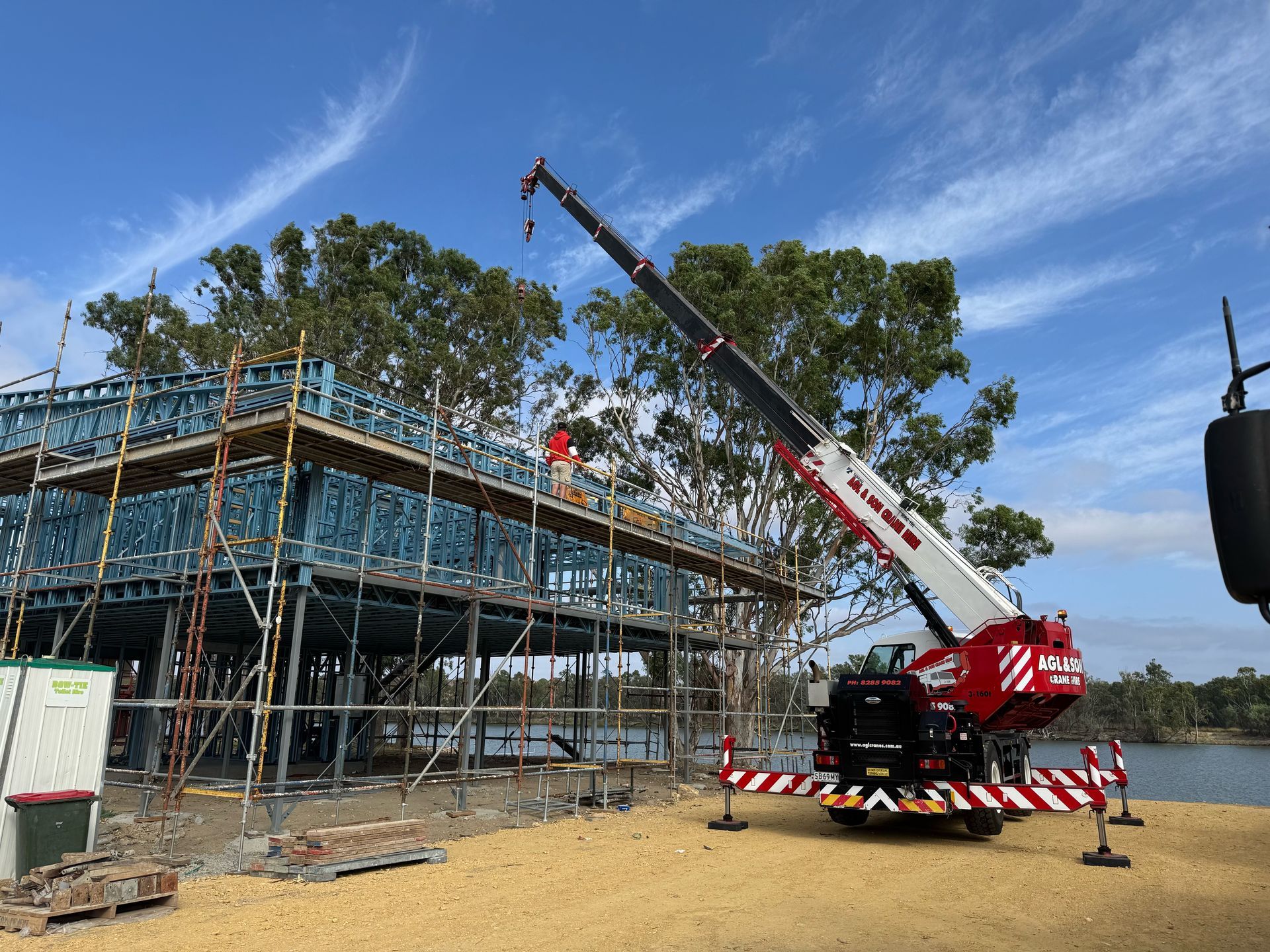 Crane operating on a building site by AGL & Son Crane Hire