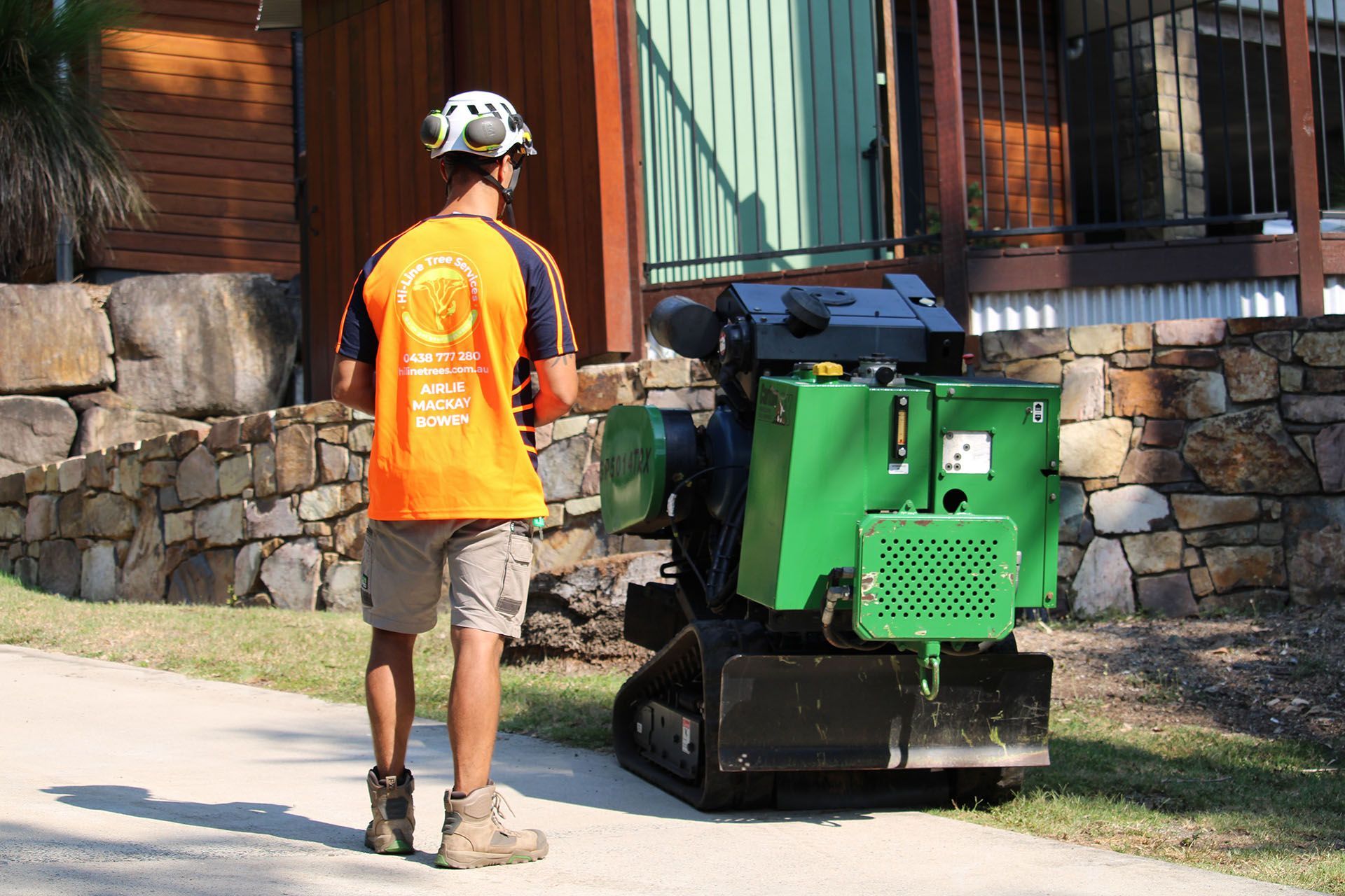 qualified tree arborist with a stump grinder