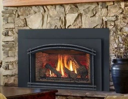 A living room with a fireplace and a vase on the mantle.
