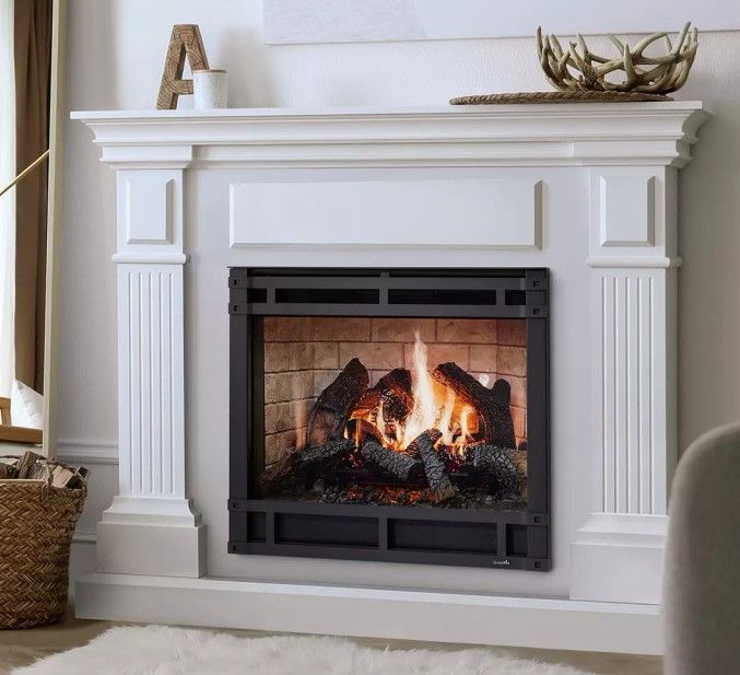 A living room with a fireplace and a white mantle.