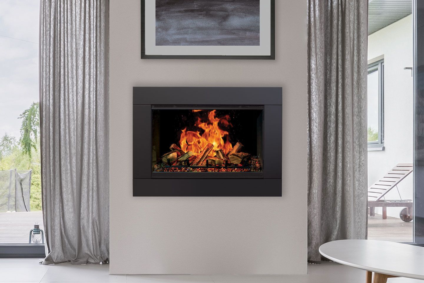 A living room with a fireplace and a picture on the wall.
