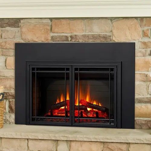A fireplace with a black frame and a brick wall