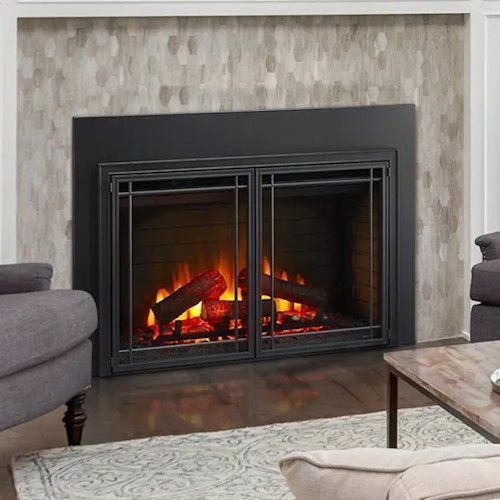 A living room with a fireplace , chairs , and a coffee table.