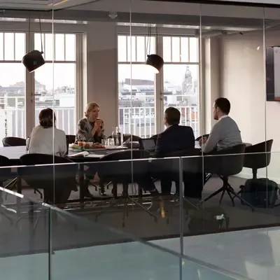 Owners of a business meeting around a table.