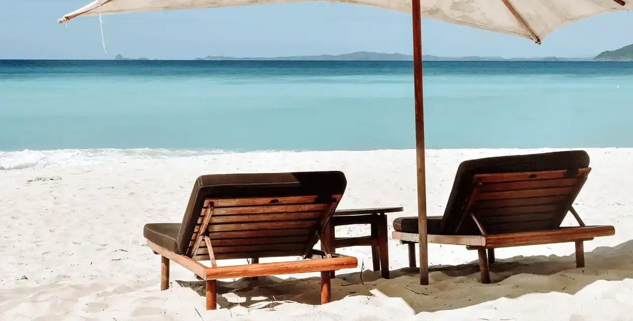 Umbrella and chairs on a beach.
