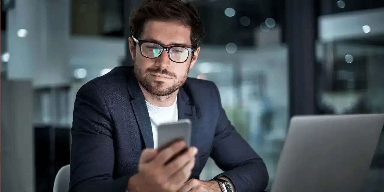 Business owner reading phone message