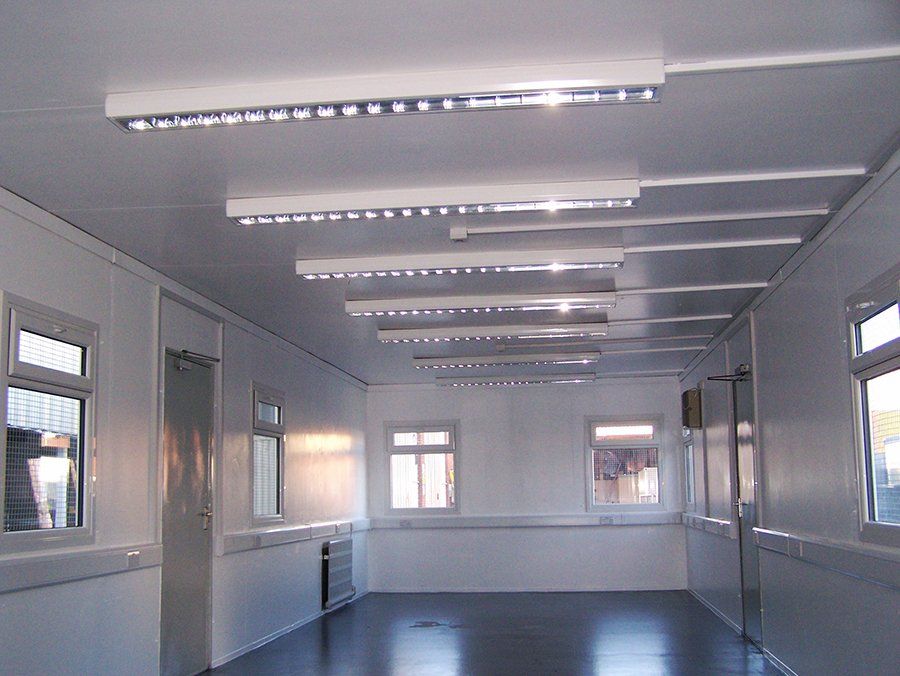 The inside of a Jackleg cabin, illuminated by several ceiling lights