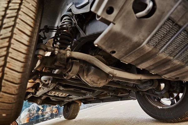 A person is checking the oil level of a car.