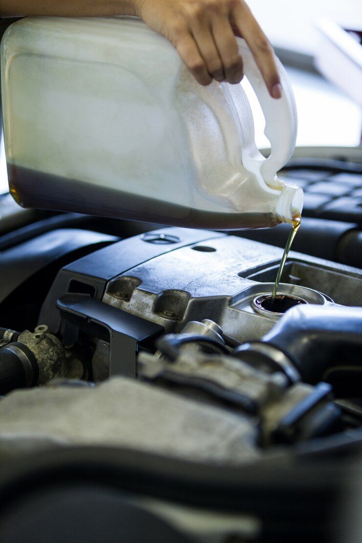 A person is checking the oil level of a car.