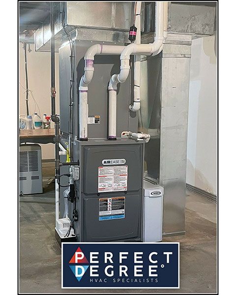 HVAC unit with ductwork in a basement setting. The unit is gray and white, with the Perfect Degree logo at the bottom.