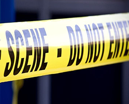 A close up of a yellow tape that says scene do not enter