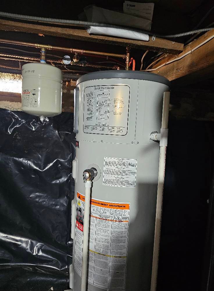 Water heater in a basement with a small expansion tank.