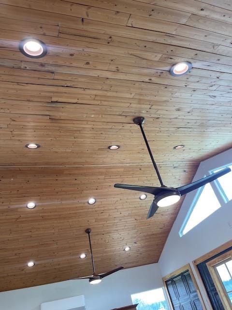 Wooden ceiling with recessed lights and ceiling fans.