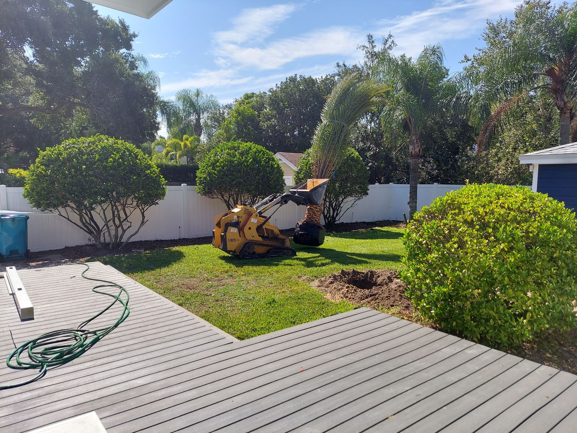 A lawn mower is sitting in the middle of a lush green yard.