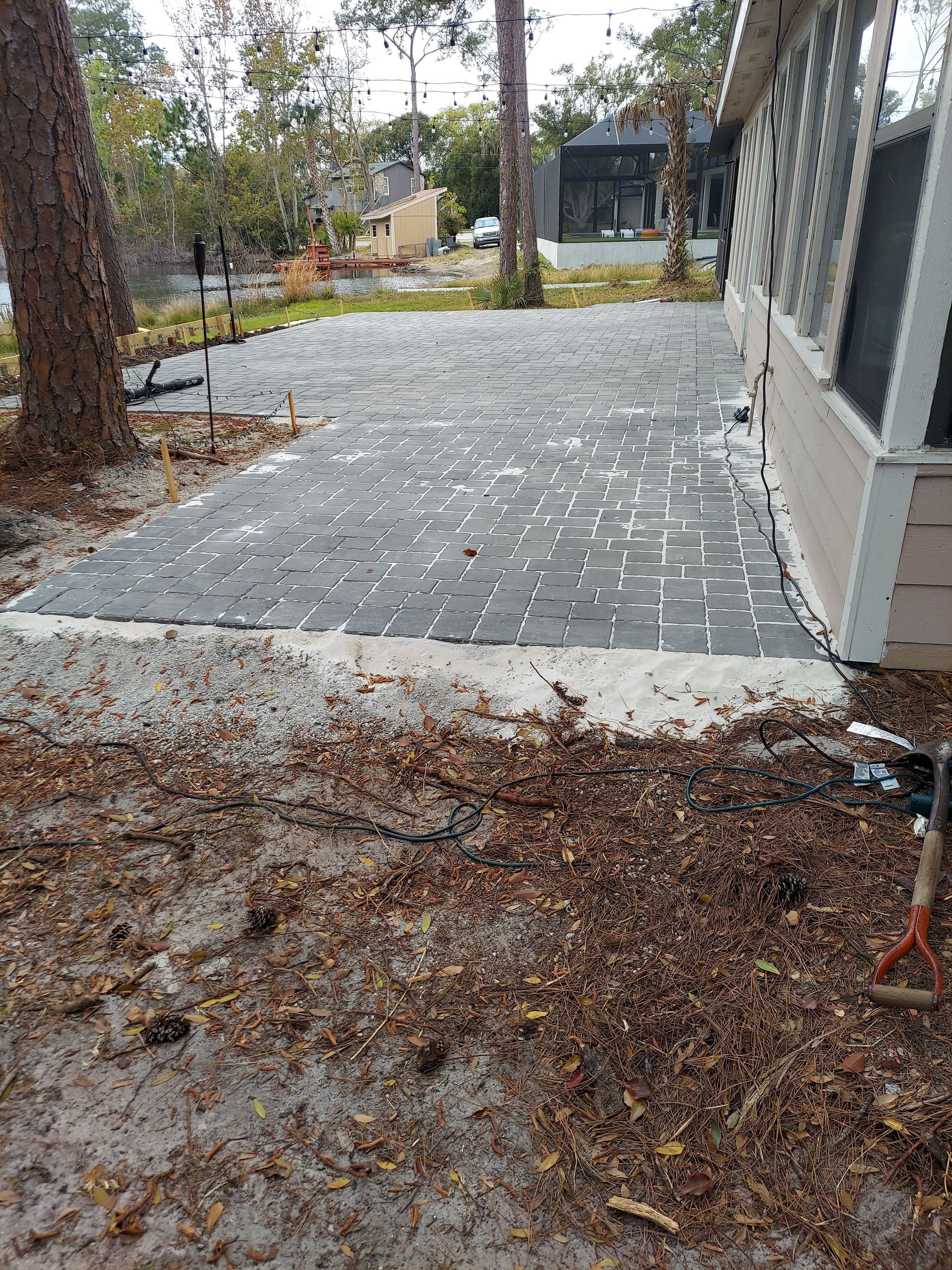A patio is being built in front of a house.