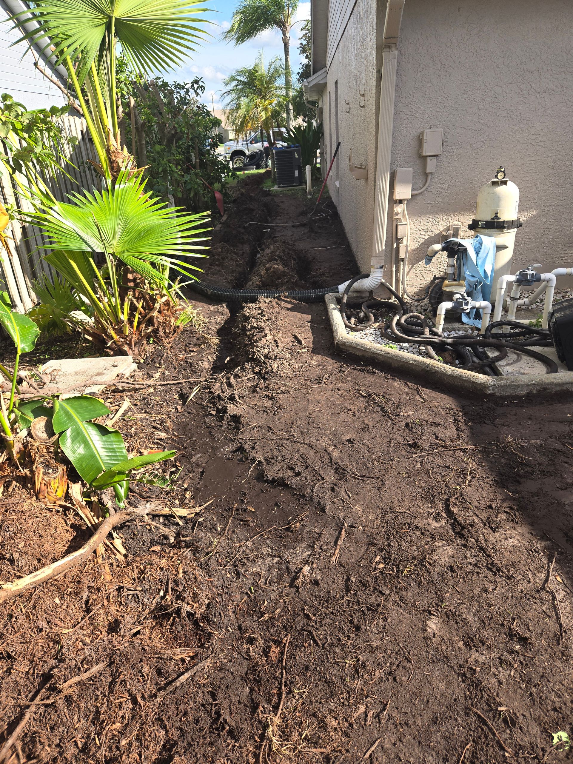 A large pile of dirt is sitting in front of a house.