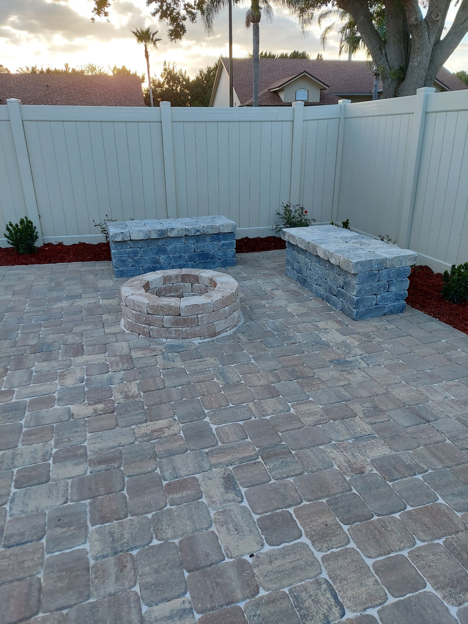 A patio with a circular design and a table and chairs