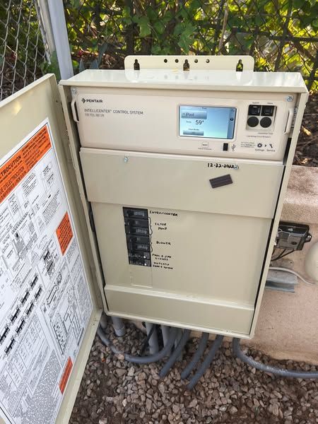 A white box with a monitor on top of it.