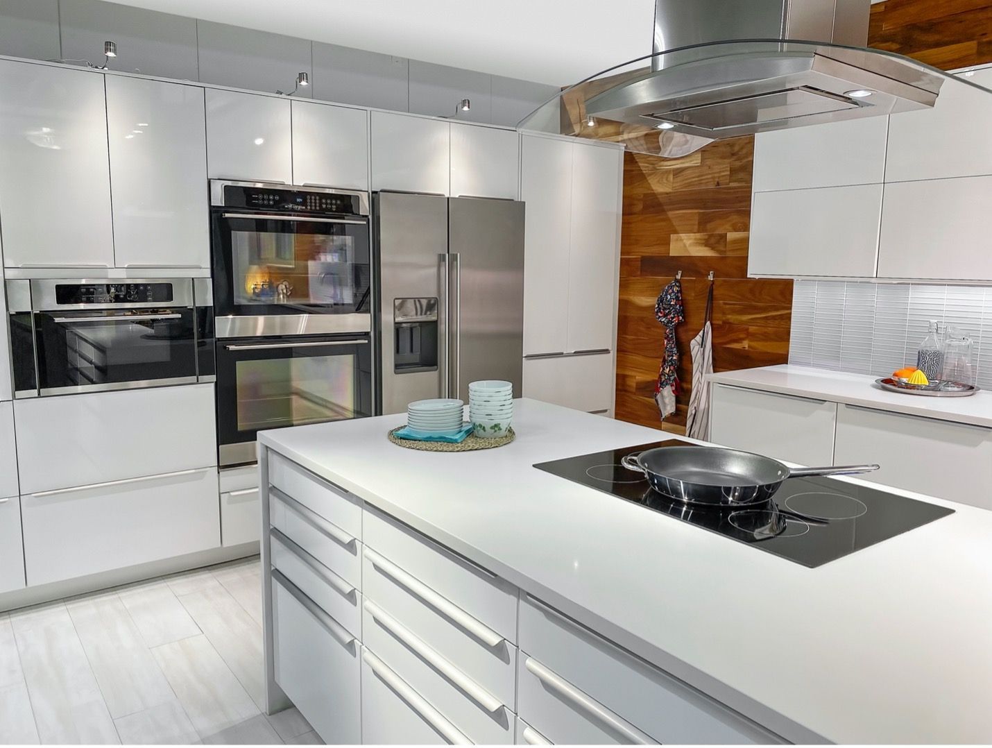 A kitchen with white cabinets and stainless steel appliances