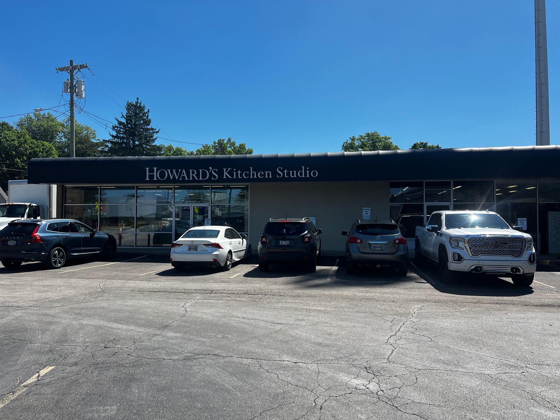 Howard's Kitchen Studio storefront with parked cars in front on a sunny day in Cincinnati, OH