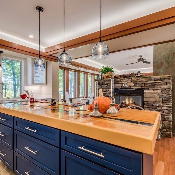 A kitchen with blue cabinets and a wooden counter top