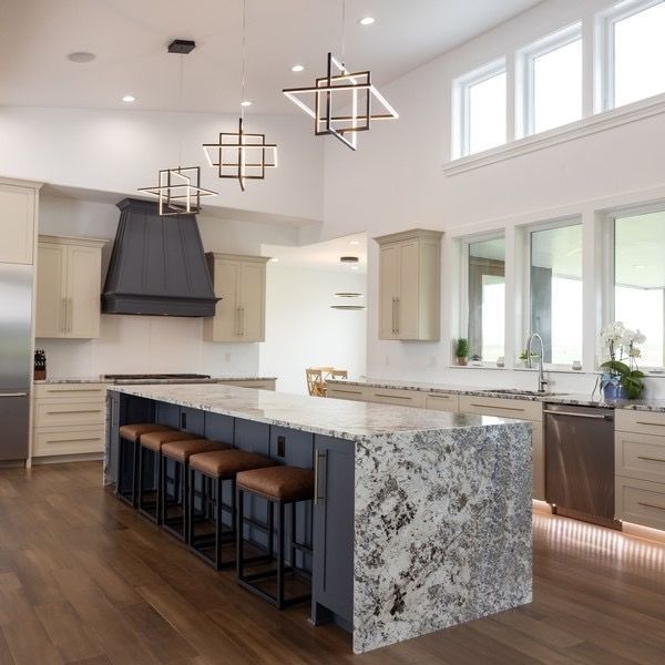 A kitchen with a large island and stools