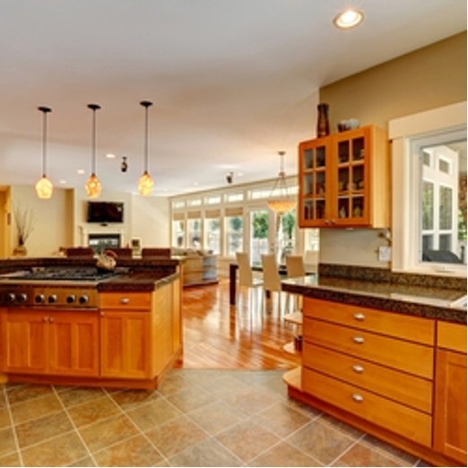 A kitchen with wooden cabinets and granite counter tops