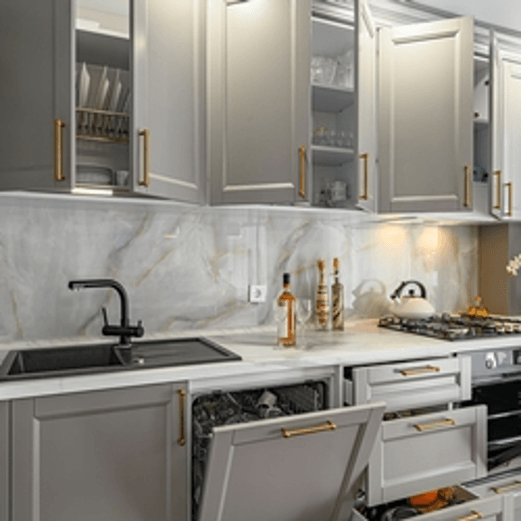 A kitchen with gray cabinets and white counter tops