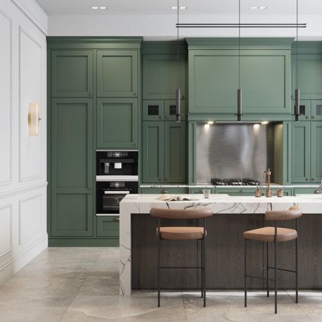 A kitchen with green cabinets and a marble counter top