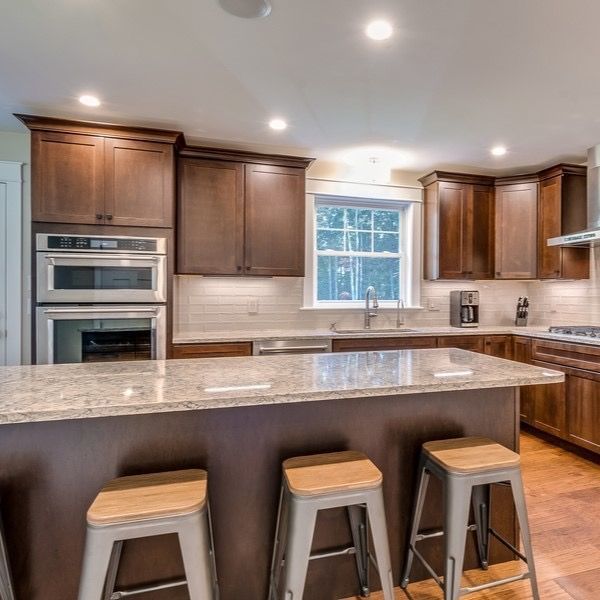 A kitchen with a large island and stools