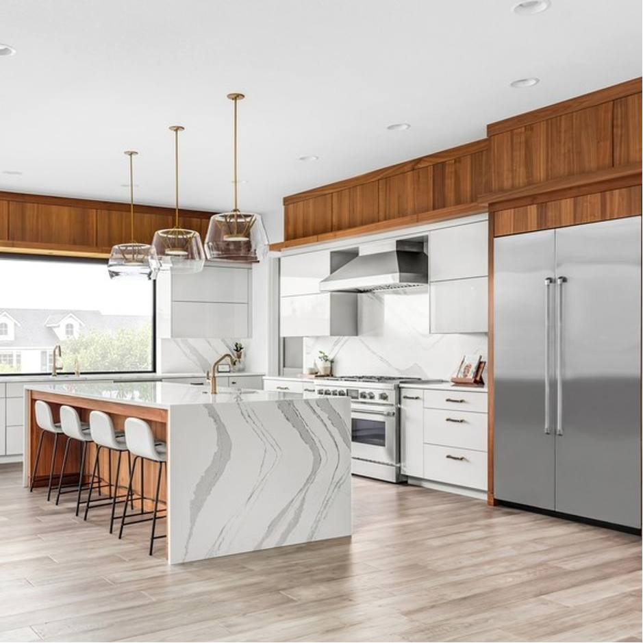 A kitchen with stainless steel appliances and a large island