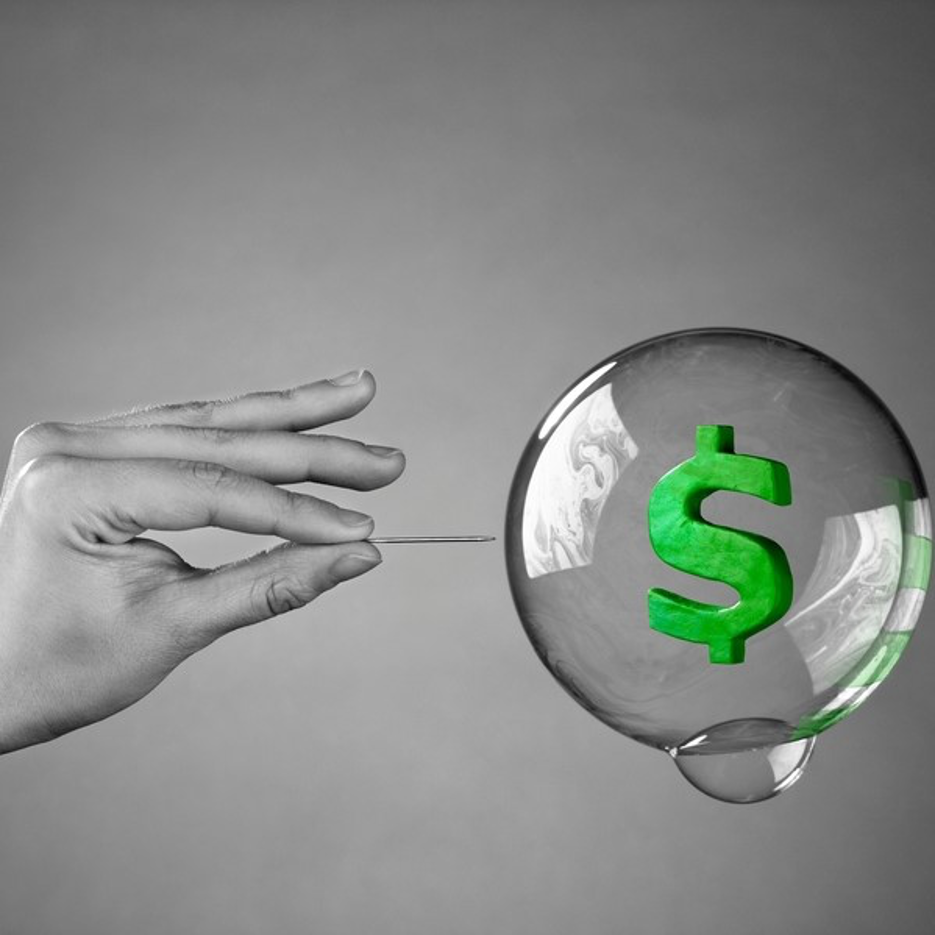 A hand is holding a green dollar sign in a soap bubble.