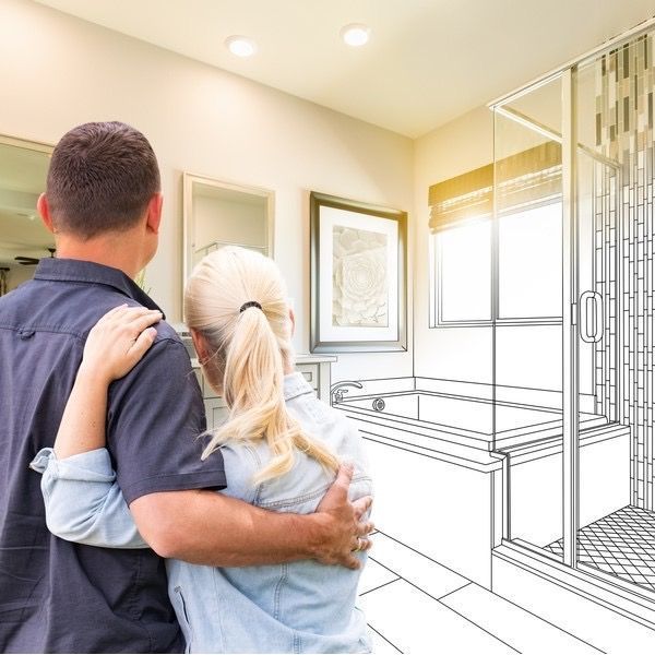 A man and woman are hugging in front of a drawing of a bathroom.