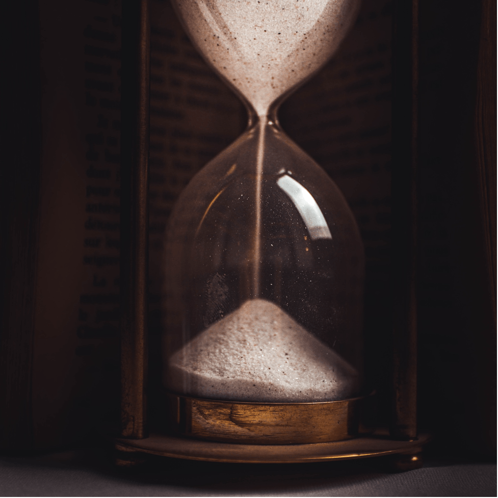A close up of an hourglass with sand pouring out of it