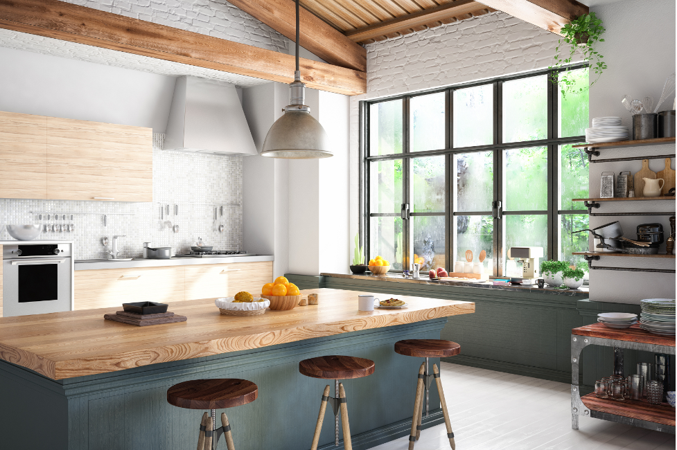A kitchen with a wooden table and stools and a large window.