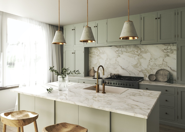 A kitchen with white cabinets , a marble counter top , a sink , and a stove.