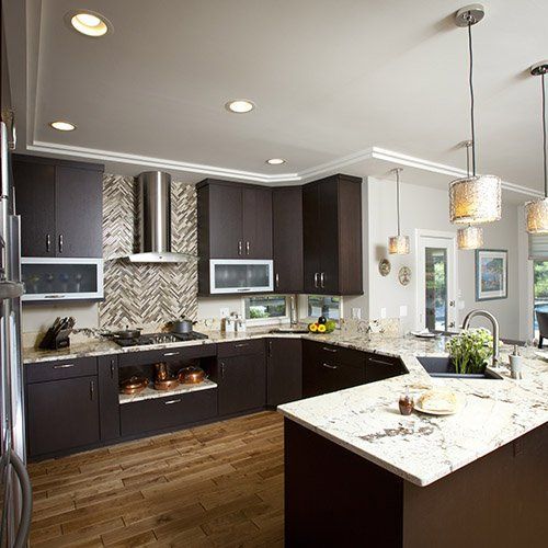 A kitchen with a large island and a skylight in the ceiling.