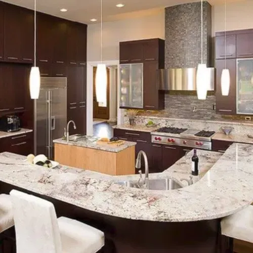 A kitchen with white cabinets and granite counter tops